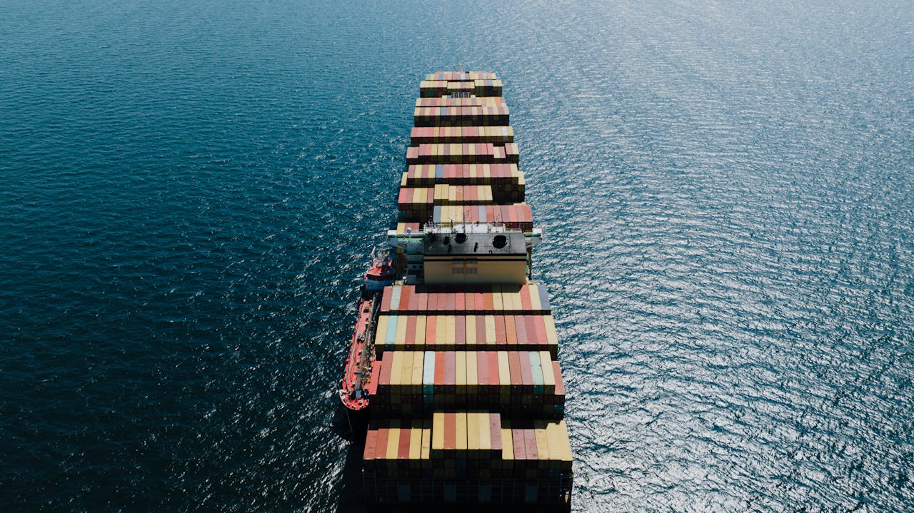 Drone shot of a loaded container ship sailing through the sea near Naples, Italy.